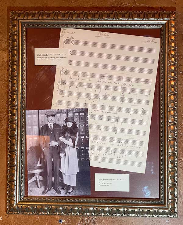 Framed display of sheet music and a photograph
