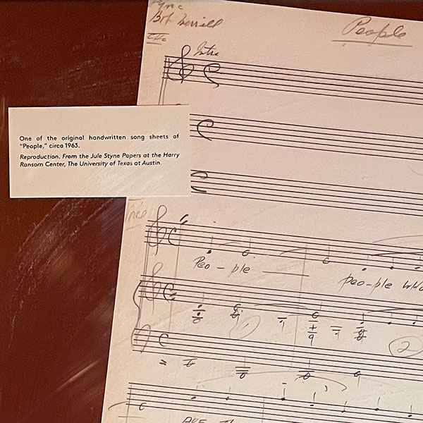 Display featuring a reproduction of an original song sheet