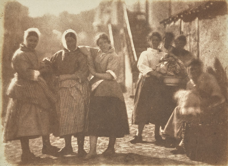 Seven fishwives posing as a group