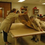 Bedford and Watkins position the poster on the Japanese backing paper.