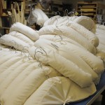 Completed hangers are stacked on a work table.