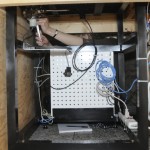 "Back view" of the stand and panel supporting the datalogger and sensor monitors. Barbara Brown is replacing the oxygen sensor. Photo by Anthony Maddaloni.