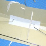 The inside of the card support showing the hanger and the twill tape before the twill tape is cinched up and tied. Photo by Mary Baughman.