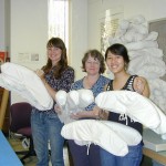 Apryl Voskamp, Mary Baughman and Liz Phan show completed hangers from the project. Photo by Olivia Primanis.