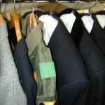 Costumes stored on ordinary hangers next to costumes on padded hangers. Photo by Mary Baughman.