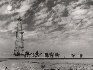David Douglas Duncan. 'Aramcovid  derrick at Abqaiq. Bedouin caravan to oblivion.' Saudi Arabia, 1947.