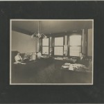 Interstate Company Staff in Chicago Office with a map of Illinois Central on side wall. Hoblitzelle-Interstate Collection.