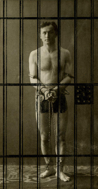 Photo of Houdini in chains in a jail cell. Undated and unidentified photographer.