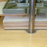 Placing the gatherings in the press to reduce swelling. To reduce the thickness caused by the extra layers of repair paper, the gatherings are pressed.