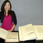 Inkyung Youm, a graduate intern in the Ransom Center's Conservation Department, with the printed and facsimile versions of William Henry Ireland's handiwork, "Miscellaneous Papers and Legal Instruments under the Hand and Seal of William Shakespeare" and "Fabricated Shakespearian Manuscripts."