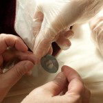 The conservation team places a weight into a mylar compartment they devised to store the weights. Photo by Pete Smith.