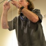 Faulk assembles the bolts between the two sheets of Plexiglas that will hold the Greenwich Village bookshop door.