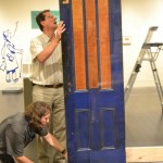 Faulk and Grant slide the door between the two panels of Plexiglas.