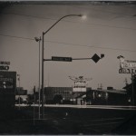 Robb Kendrick. "Untitled: Elko, Nevada series for National Geographic Magazine," July 2003. "This image was taken in 2003 in Elko Nevada for National Geographic. This was a small story about the town. It was the first time NG had ever commissioned a tintype as the process was obsolete by the time they started publishing images in 1887. The street scene taken at dusk showing the motel and casino signs, street light and car headlights was an image I attempted to show the Night Life in this gambling town. Tintype exposures are very long to begin with, at dusk they are painfully long. In the end I made three plates and the two that were successful were made with 14 minute exposure times which was far longer than any exposure I had ever heard from historic or contemporary tintype photographers. Also, I had never seen an image made after the sun went down."