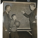 Clair Bree (left) and Howard Cann diagram play for a basketball clinic. "New York Journal-American," December 12, 1948.