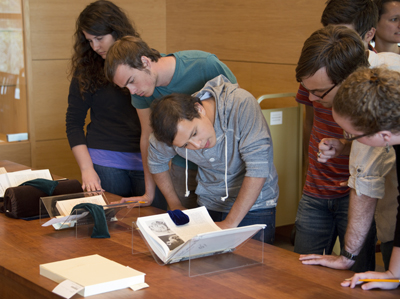Students in the David Foster Wallace course view a cinema book that Wallace read while working on “Infinite Jest.” Photo by Pete Smith.