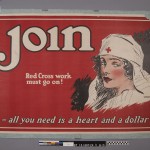 Before treatment: the poster is lined with a blue cloth. The poster is wrinkled and has a large loss near the upper right corner. Photo by Heather Hamilton.