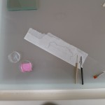 Tools used for preparing the fill. Mylar with an outline of the loss, Japanese paper to be cut to size, a water pen to help tear the paper with a soft edge, wheat starch paste to adhere the fill in place. Photo by Heather Hamilton.