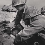 David Douglas Duncan. "A fallen U.S. Marine is given aid for his wounds and comfort by his comrades." Korea, 1950.