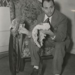 SIP publicity photo of John Frederics with two hats, 1939.