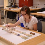 Head of Paper Conservation Heather Hamilton treats an animated Movie Jecktor scroll for the exhibition on “Alice in Wonderland.” Photo by Alicia Dietrich.