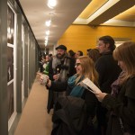Guests view photographs at the pop-up exhibition at the Ransom Center with images from Alec Soth and Brad Zellar’s “Texas Triangle” project. Photo by Pete Smith.