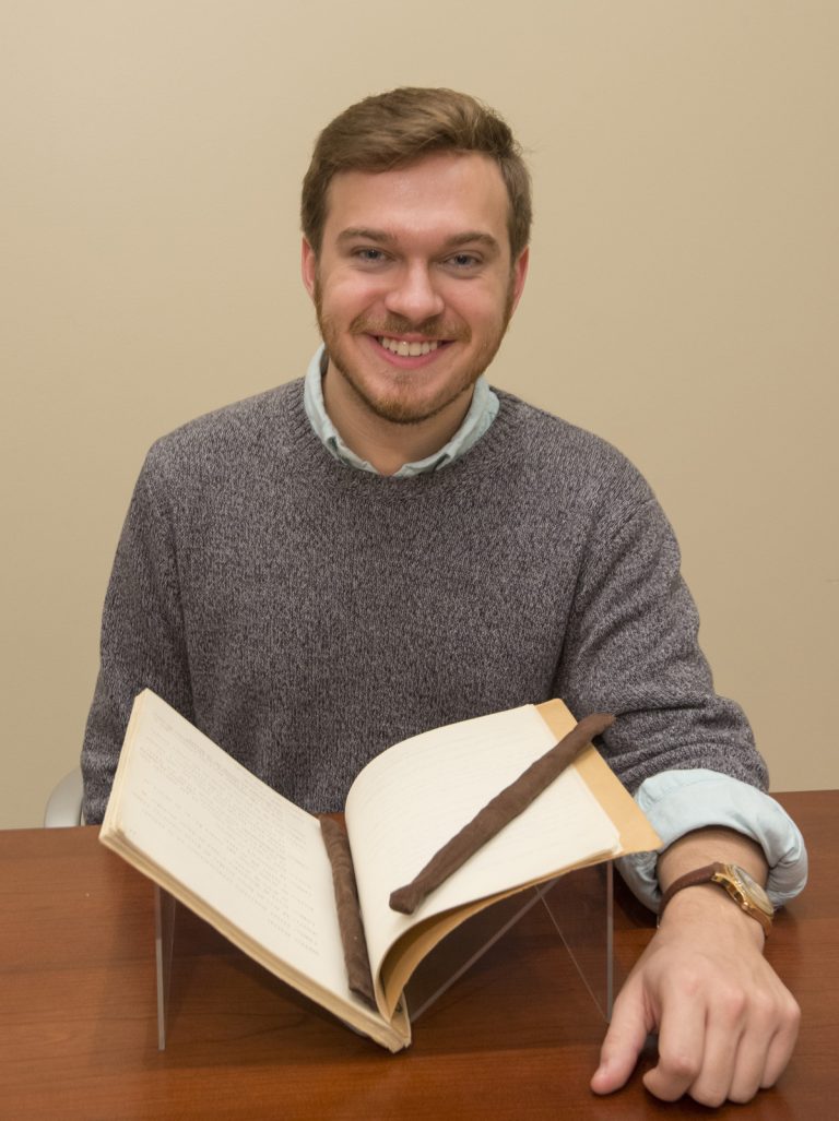 Kenneth Williams working with archive materials.