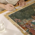 Softening adhesive on the border of the drawing, "The Christening Party" by W. H. Robinson. Photo by Eric Beggs.