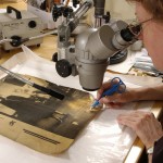 Surface cleaning a portrait of British author Ivy Compton-Burnett. Photo by Eric Beggs.