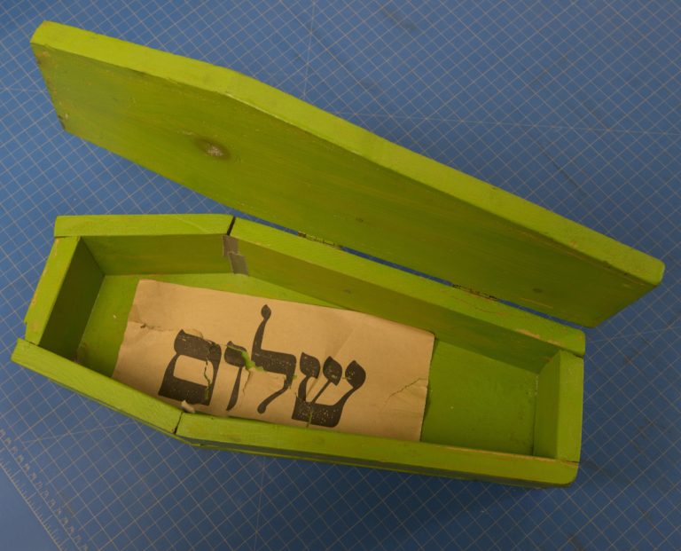 Paper found underneath sugar, with Yiddish word shalom. Photo by Pete Smith.