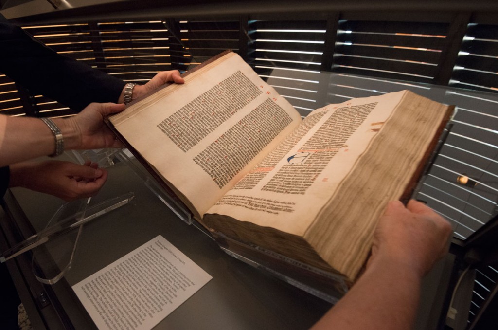 Conservators turn the pages to display the Book of Ezekiel in the Gutenberg Bible. Photo by Pete Smith.