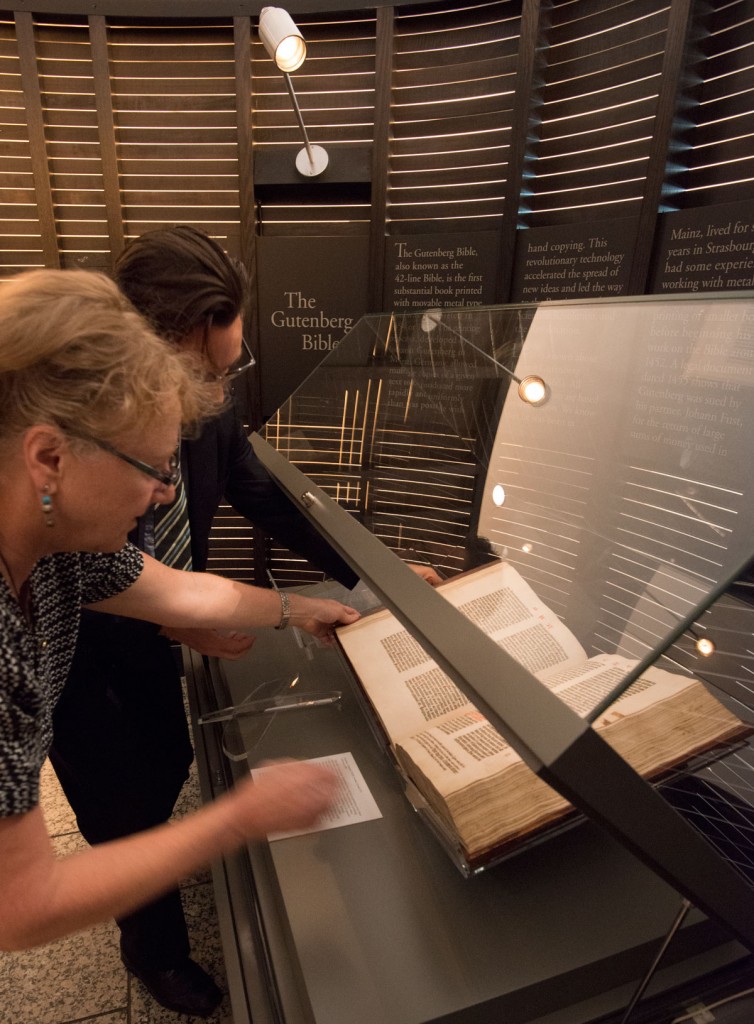 Ransom Center staff place the Gutenberg Bible in the display case with exhibition label. Photo by Pete Smith.