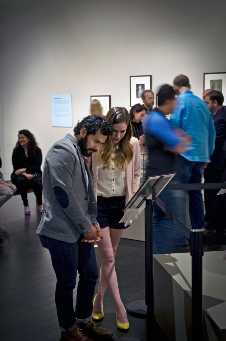 Adrian Rocha viewing the exhibition "Shakespeare in Print and Performance."