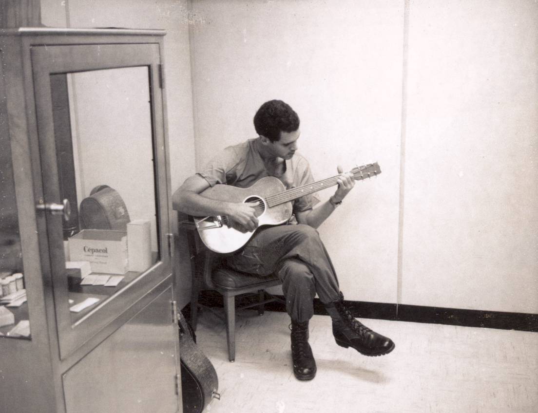 Dean Echenberg with guitar during his service in Vietnam