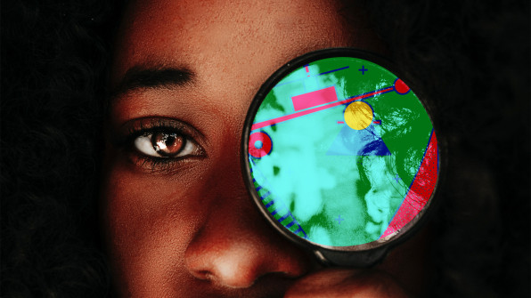 A Black woman viewing a graphic through a lens