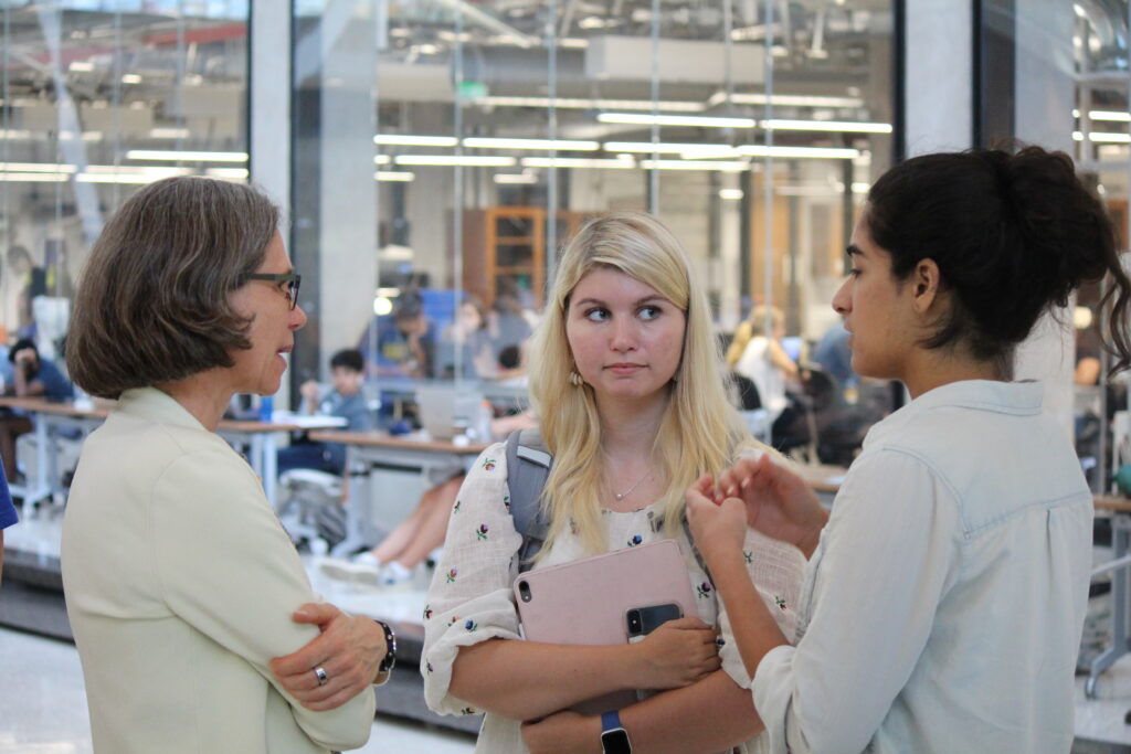 Dean Wood conversing with two students