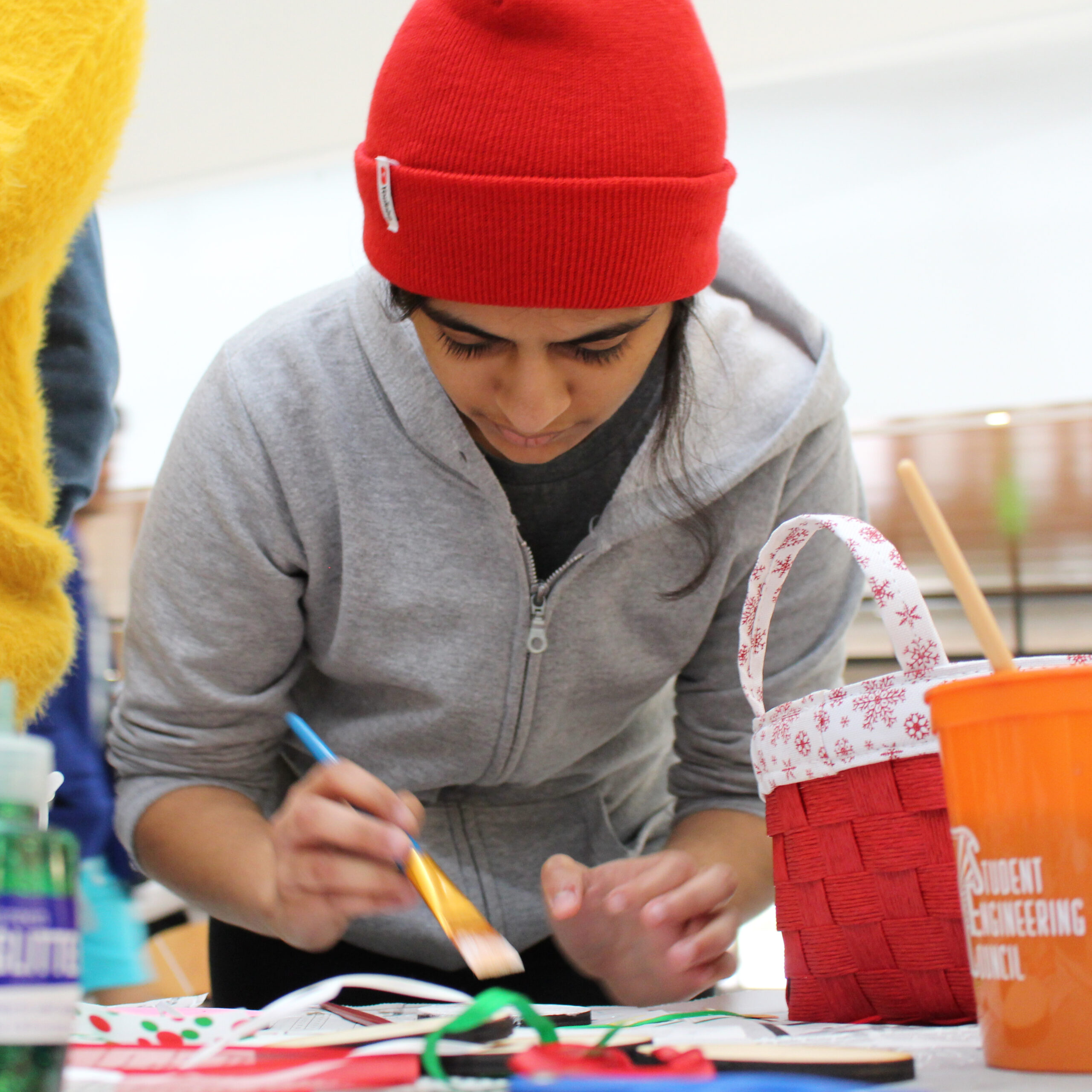 Student painting a laser-cut ornament for Study Breaks