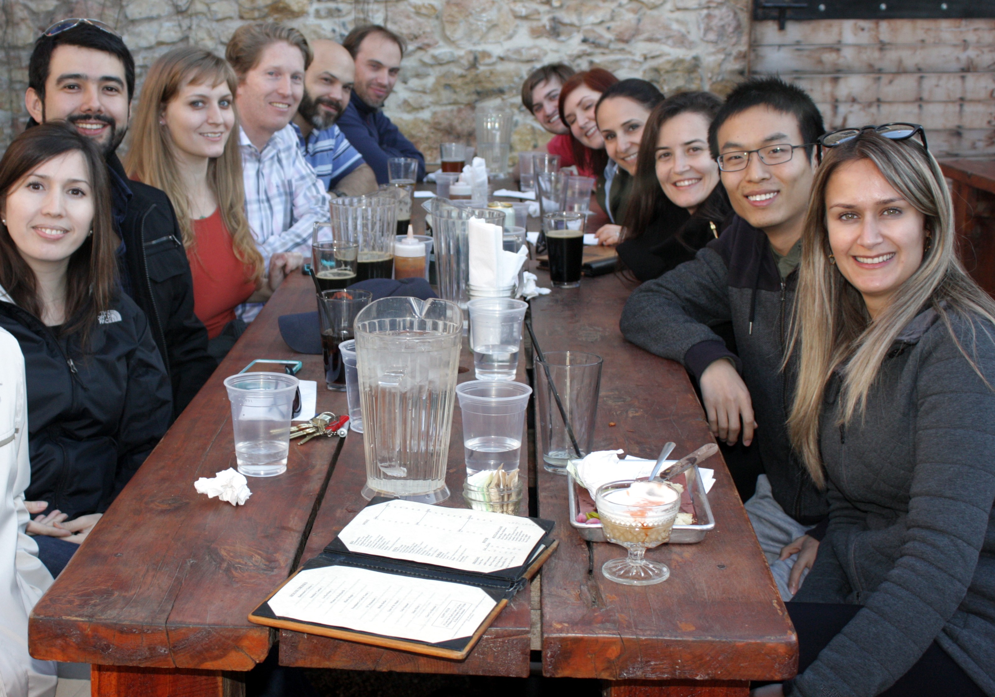 Lab social event with 12 lab members and Dr. Smyth seated at an outdoor restaurant table.