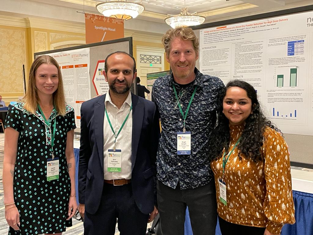 Jamie Spahn, Amr Hefnawy, Dr. Smyth, and Varsha Nair standing in front of research poster at Drug Delivery 2022.