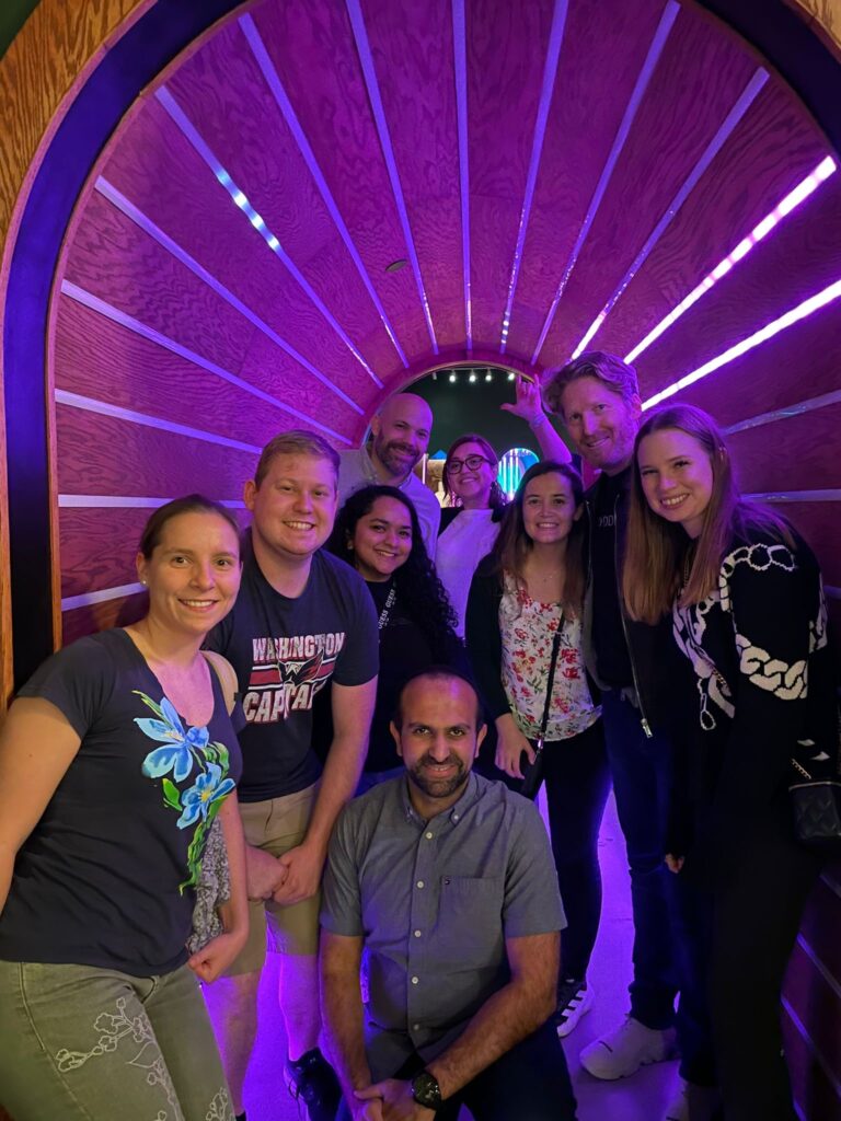 Lab social event with lab members and Dr. Smyth in a purple tunnel.