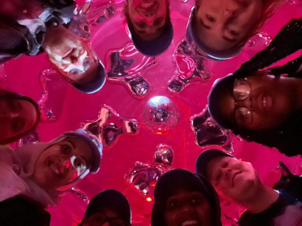 Photo of lab members faces in a circular formation