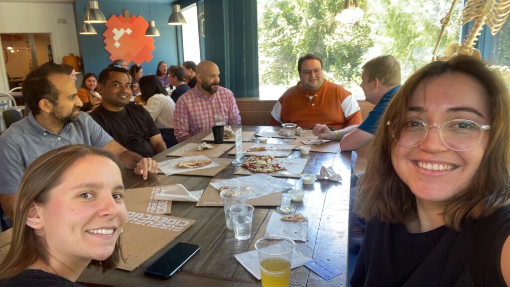 Lab social event with lab members gathered around a restaurant table.