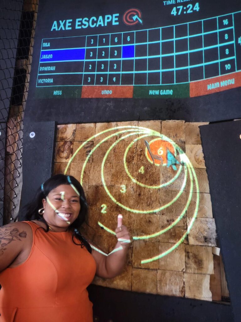 Jailen gives thumbs up after throwing axe.