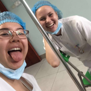 Niki and Christina posing in scrubs on their first day in Oncology