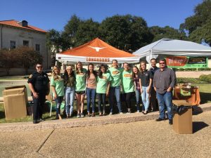 Students and UT personnel standing in front of burnt orange tent