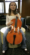 A student with a cello her size