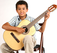 A student holding a classical guitar