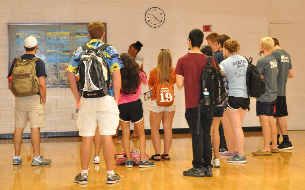 Chrystina Wyatt leading a group of UT Orientation students on a tour of a Gregory Gym aerobic studio