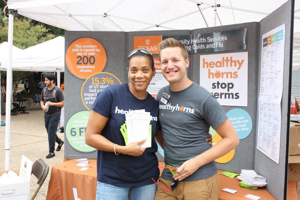 Erika Holmes and Ryan LaDue hand out information about preventing colds and flu at UHS’ annual Healthyhorns Fest event