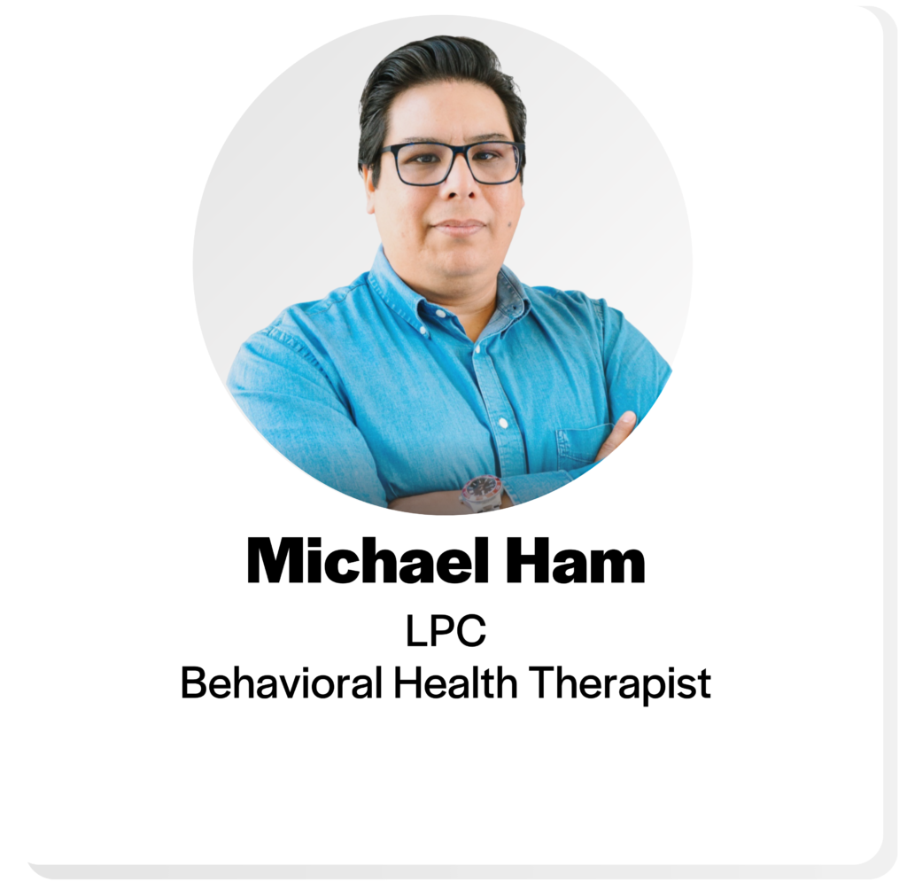 headshot of a man with short dark hair and glasses and a blue button down shirt, with the title Michael Ham, L P C, behavioral health therapist